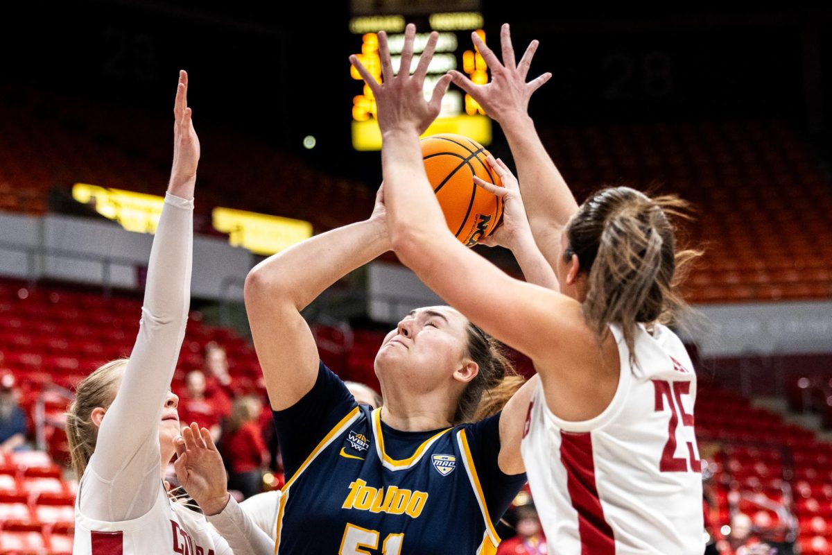 Beyonce Bea and Tara Wallack combine to defend a Toledo attack, March 29, in Pullman, Wash. 