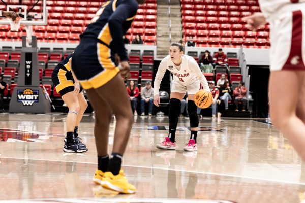 Astera Tuhina dribbles and stares at the shot clock as the Cougs set up an offensive set, March 29, in Pullman, Wash. 