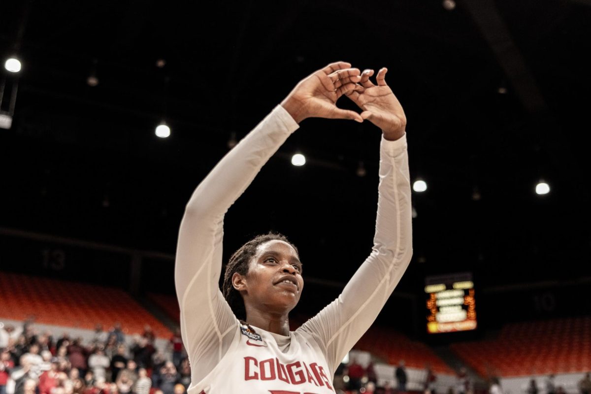 Bella Murekatete gives a heart to the crowd after the Cougs win, March 29, in Pullman, Wash. 