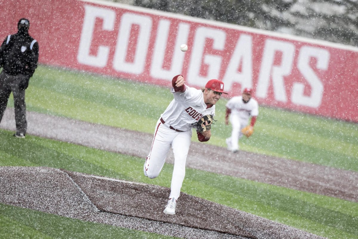 Connor Wilford throwing a pitch in the snow against Rhode Island, March 2, in Pullman, Wash.