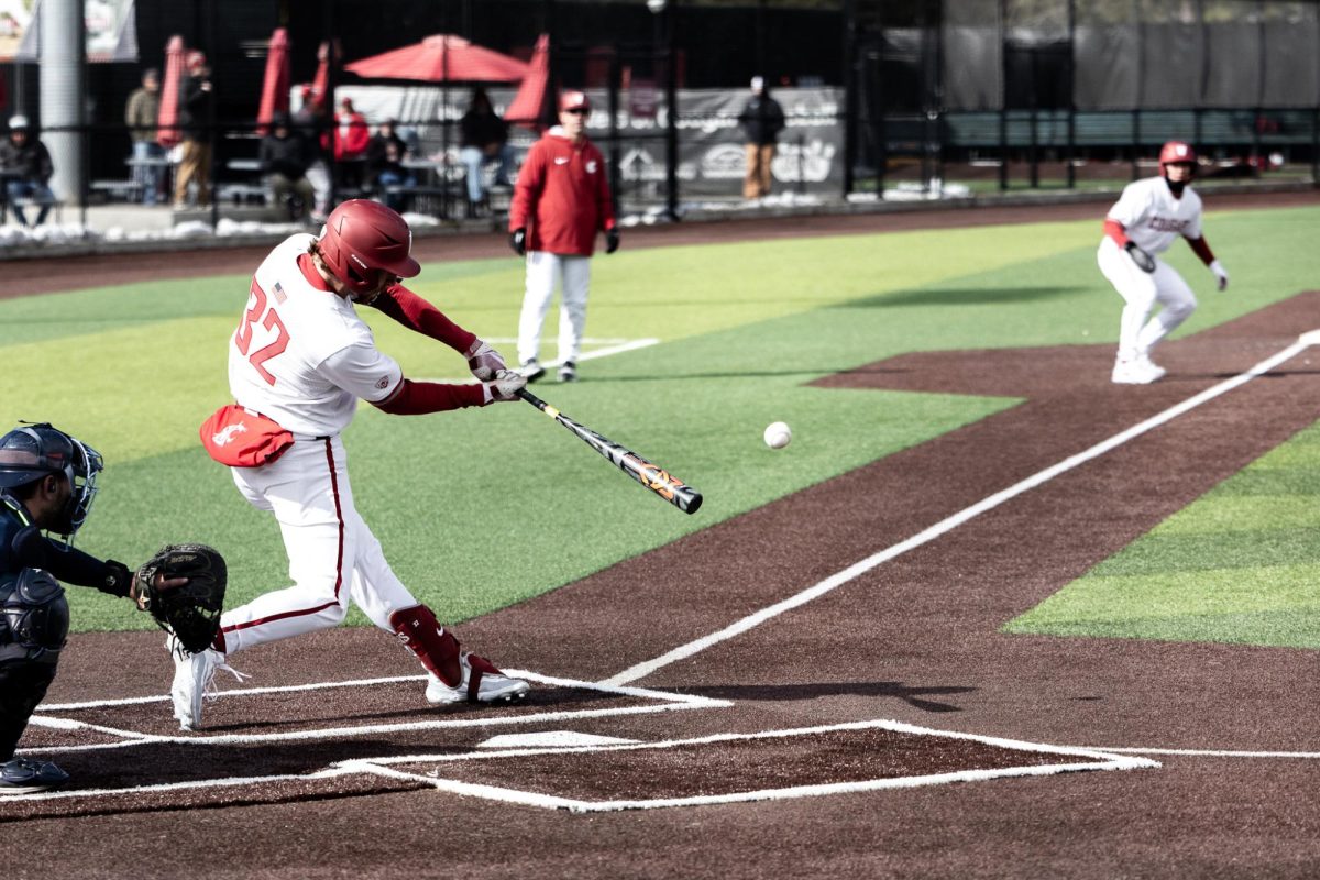 Cole Cramer barrels up the ball for one of his three hits in game one of the doubleheader against Rhode Island, March 2, in Pullman, Wash.