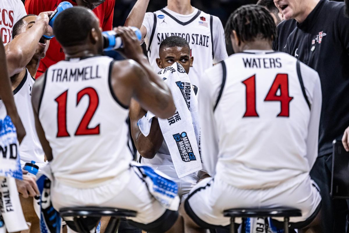 SDSU guard Lamont Butler wipes sweat off of his face during a timeout, March 22, 2024, in Spokane, Wash.