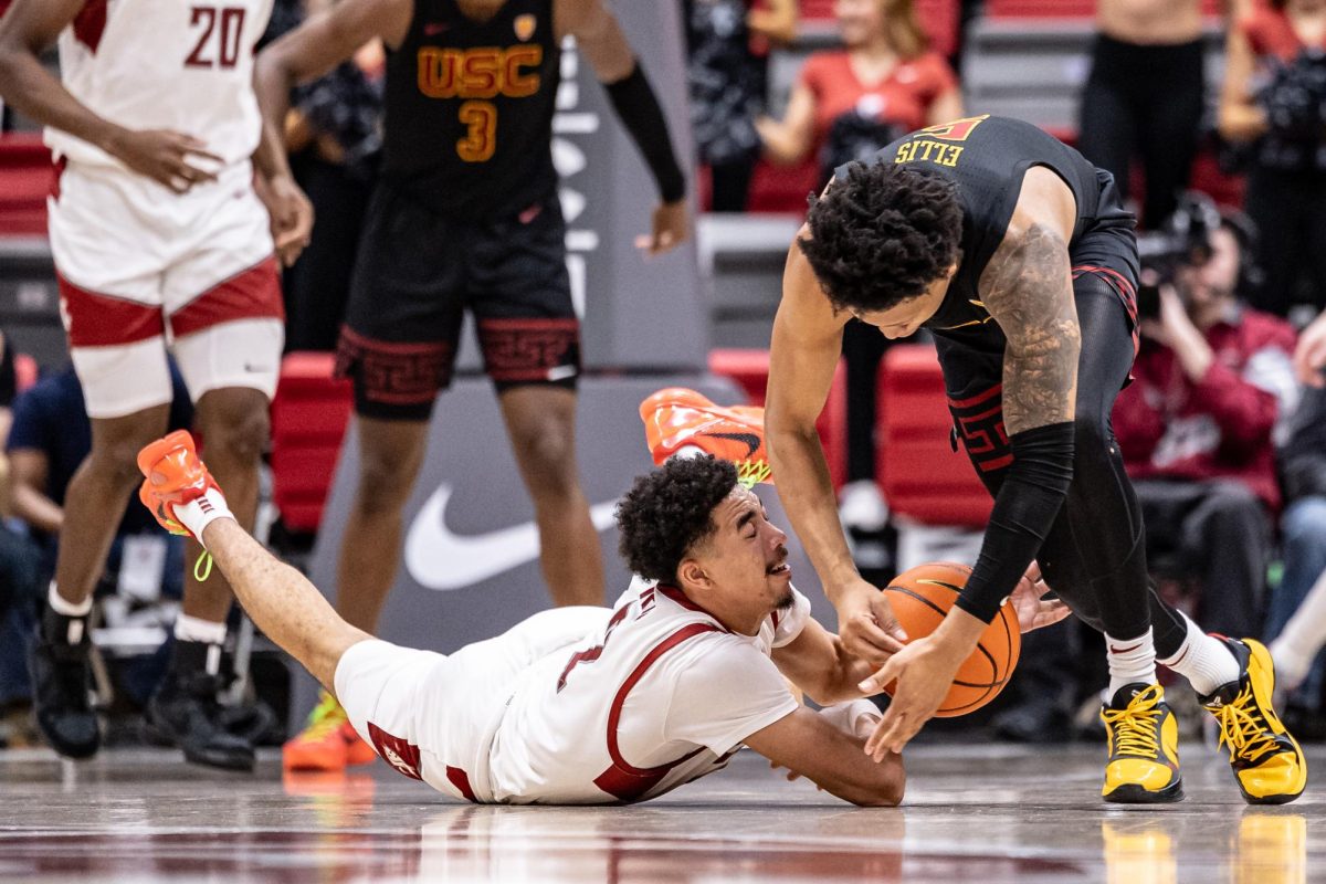 WSU guard Myles Rice dives for a loose ball during an NCAA men’s basketball game against USC, Feb. 29, 2024, in Pullman, Wash.