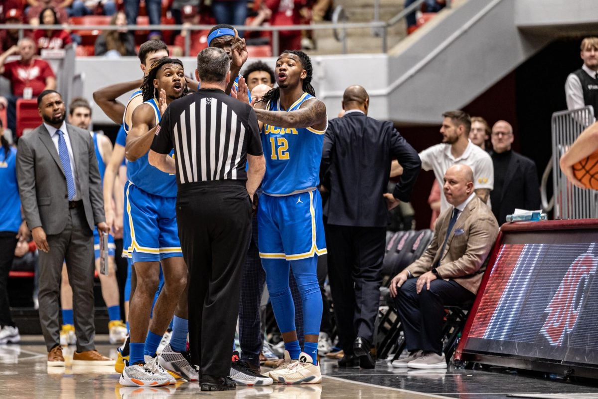 UCLA players argue with an official after guard Will McClendon received a flagrant foul call during an NCAA men’s basketball game against WSU, March 2, 2024, in Pullman, Wash.