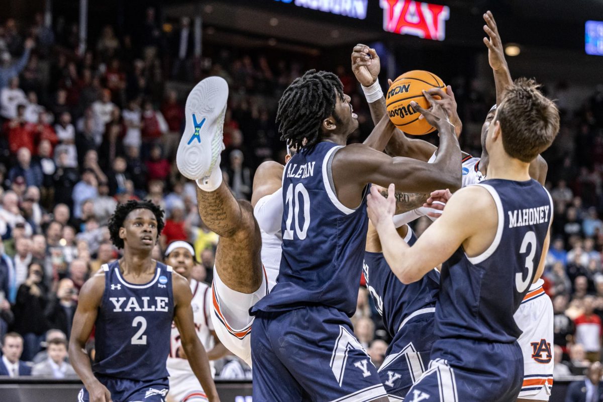 Yale and Auburn players battle for a rebound in the final minute of their firs-round match, March 22, 2024, in Spokane, Wash.