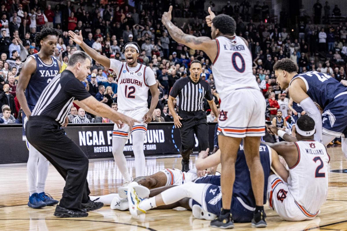 Officials call a jump ball during the final minutes of a first-round match between Auburn and Yale, March 22, 2024, in Spokane, Wash.