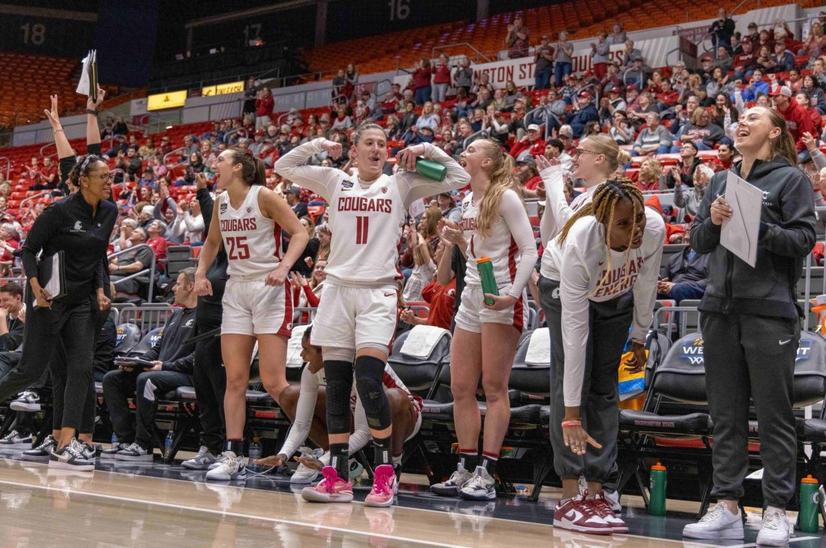 Beyonce Bea, Astera Tuhina, Tara Wallack and other members of the WSU bench celebrate during the fourth quarter, March 24 in Pullman, Wash.