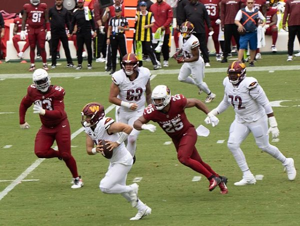 Washington Commanders quarterback, Sam Howell, scrambles during a game against the Arizona Cardinals at FedEx Field on September 10, 2023. 
Courtesy of flickr user dbking via Wikimedia