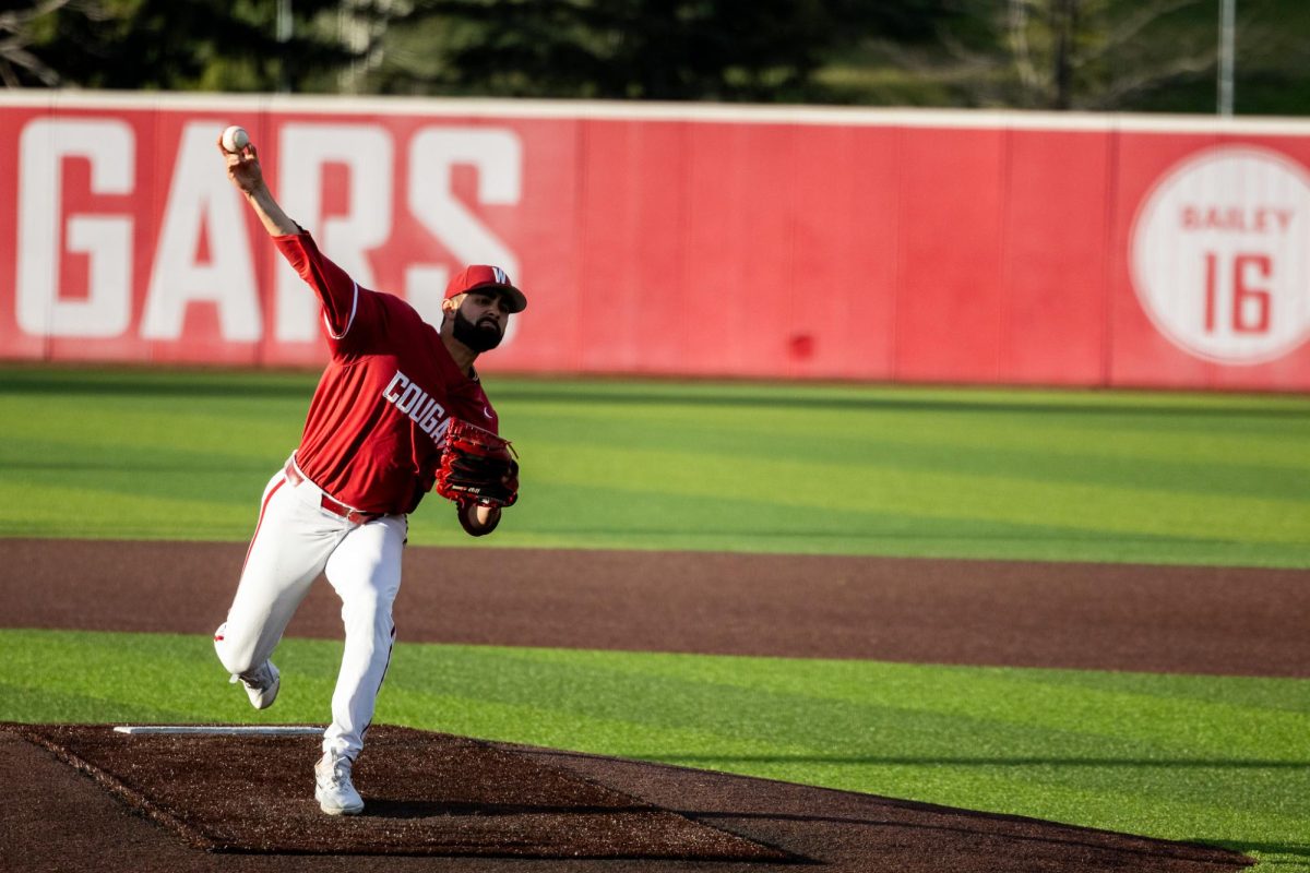 Grant Taylor, draped in shadows, throws a pitch to a Fresno State batter, April 26, in Pullman, Wash. 