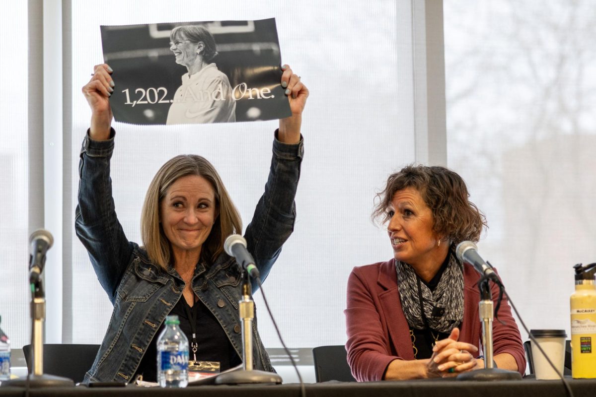 Murrow scholarly assistant proffesor Wendy Raney (L) proudly holds up a Tara VanDerveer poster gifted to her by the visiting Janie McCauley (R) during their panel to talk about women breaking boundries in sports, April 3, in Pullman, Wash. 
