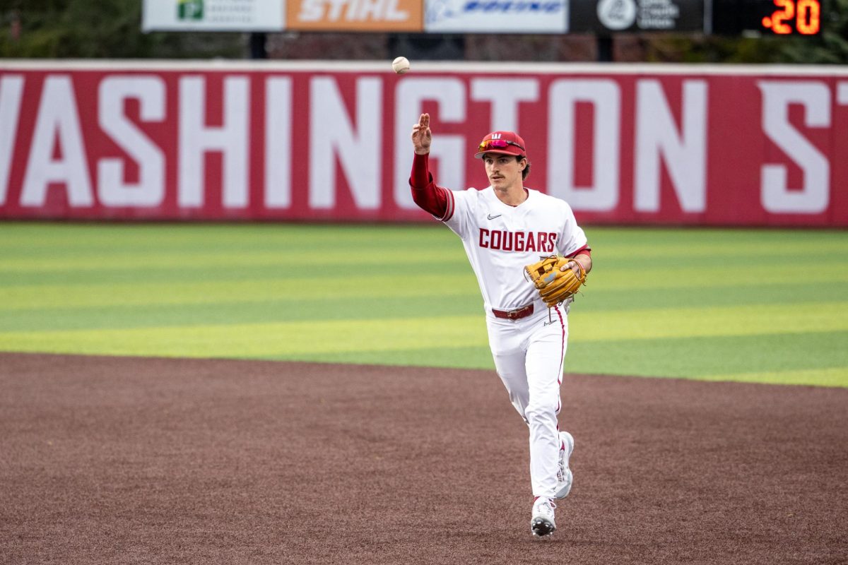 Crew Parke lightly tosses the ball over to first play to get an out during the first inning of a game against Cal, April 12, in Pullman, Wash. 