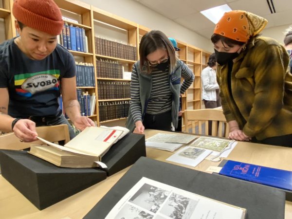 Attendees look over the Virginia Woolf collection, books known for pushing the boundaries of gender roles in the 1920s, March 28, 2024, in Pullman, Washington.