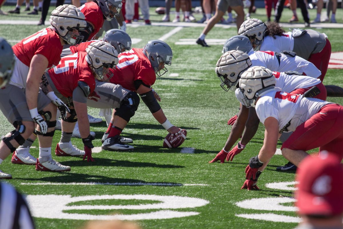 WSU football players face off during practice, April 22, in Martin Stadium..
