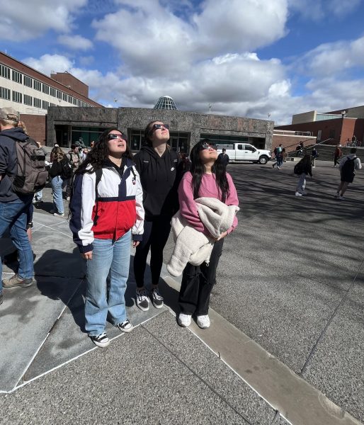 Students on Glenn-Terrell Mall looking up to see the partial eclipse on Monday, April 8.