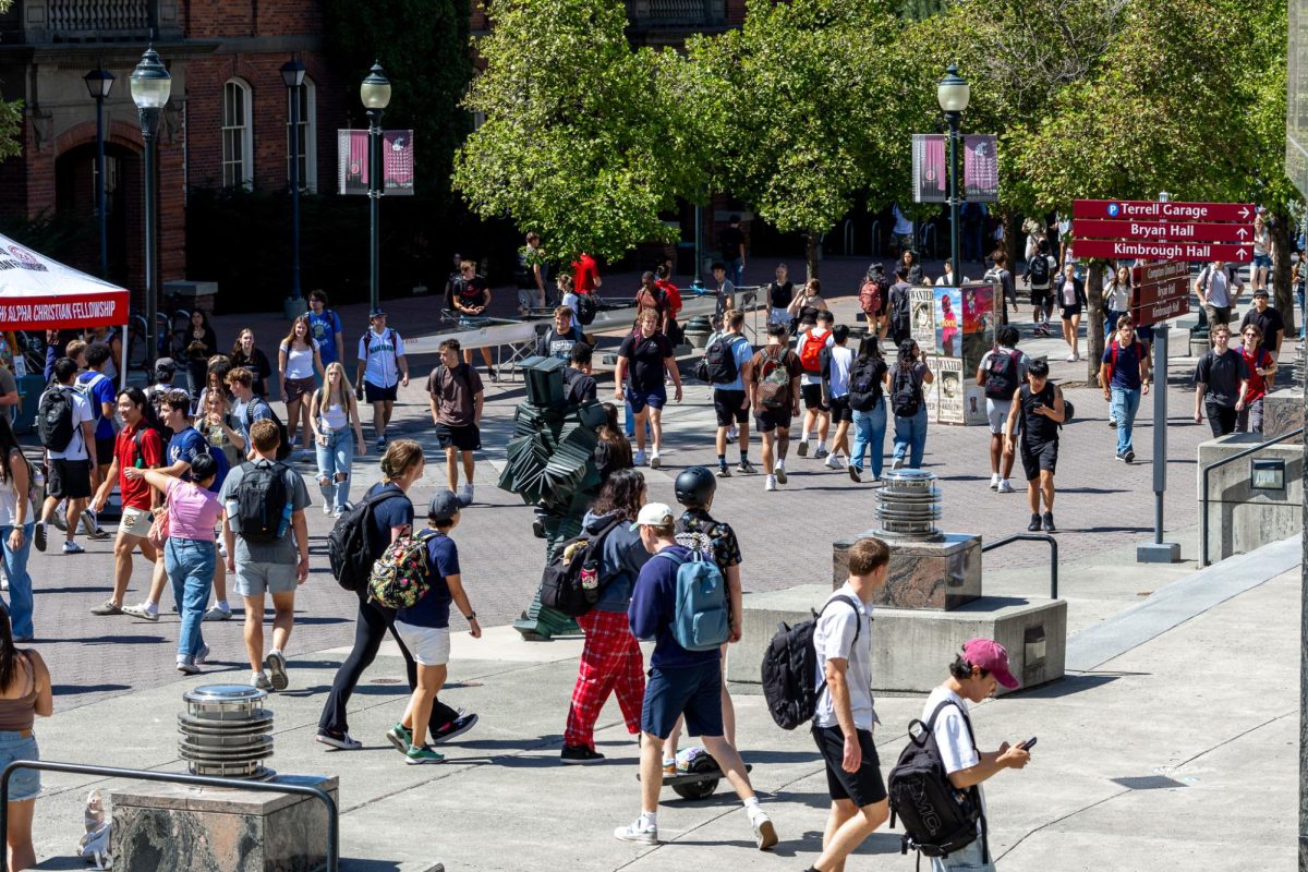 WSU students walk the mall in between classes on the first day of the fall semester, Aug. 19, in Pullman, Wash. 