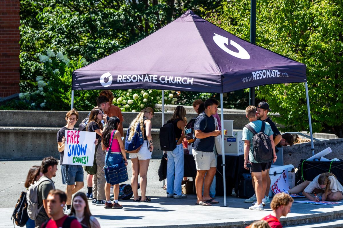 WSU students walk the mall in between classes on the first day of the fall semester, Aug. 19, in Pullman, Wash. 