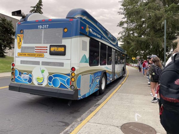 Students waiting at Apartment Land Bus stop by Beasley Coliseum