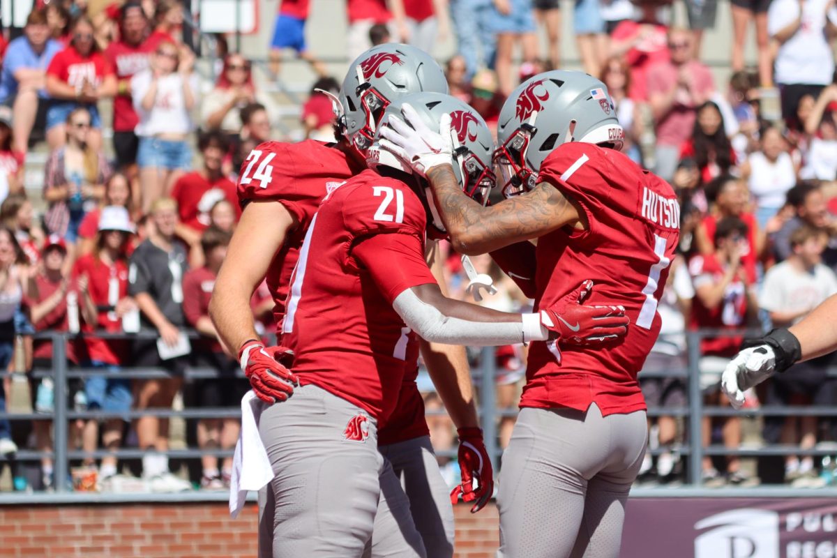 WSU running back Wayshawn Parker (21) celebrates with teammates after scoring a touchdown in the Cougs win over the Portland State Vikings at Gesa Field Saturday August 31.