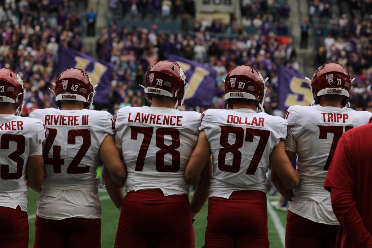 WSU football players stand for the National Anthem before the 2024 Apple Cup