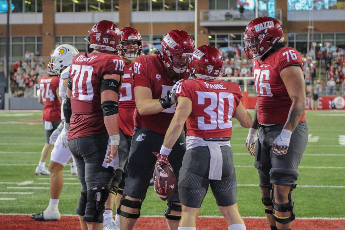 WSU RB Dylan Paine celebrates a touchdown with his offensive linemen.