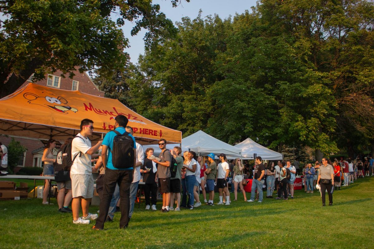 People lined up at the Munchy'z tent at CougFest 2024, Sept. 6, in Pullman, Wash.