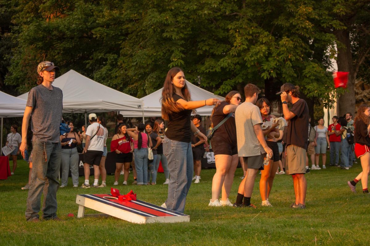 People playing cornhole at CougFest 2024, Sept. 6, in Pullman, Wash.