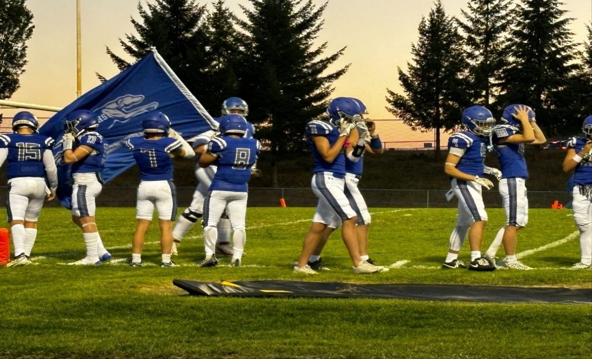 Pullman Greyhounds football team takes the field for a Friday night game against Deer Park