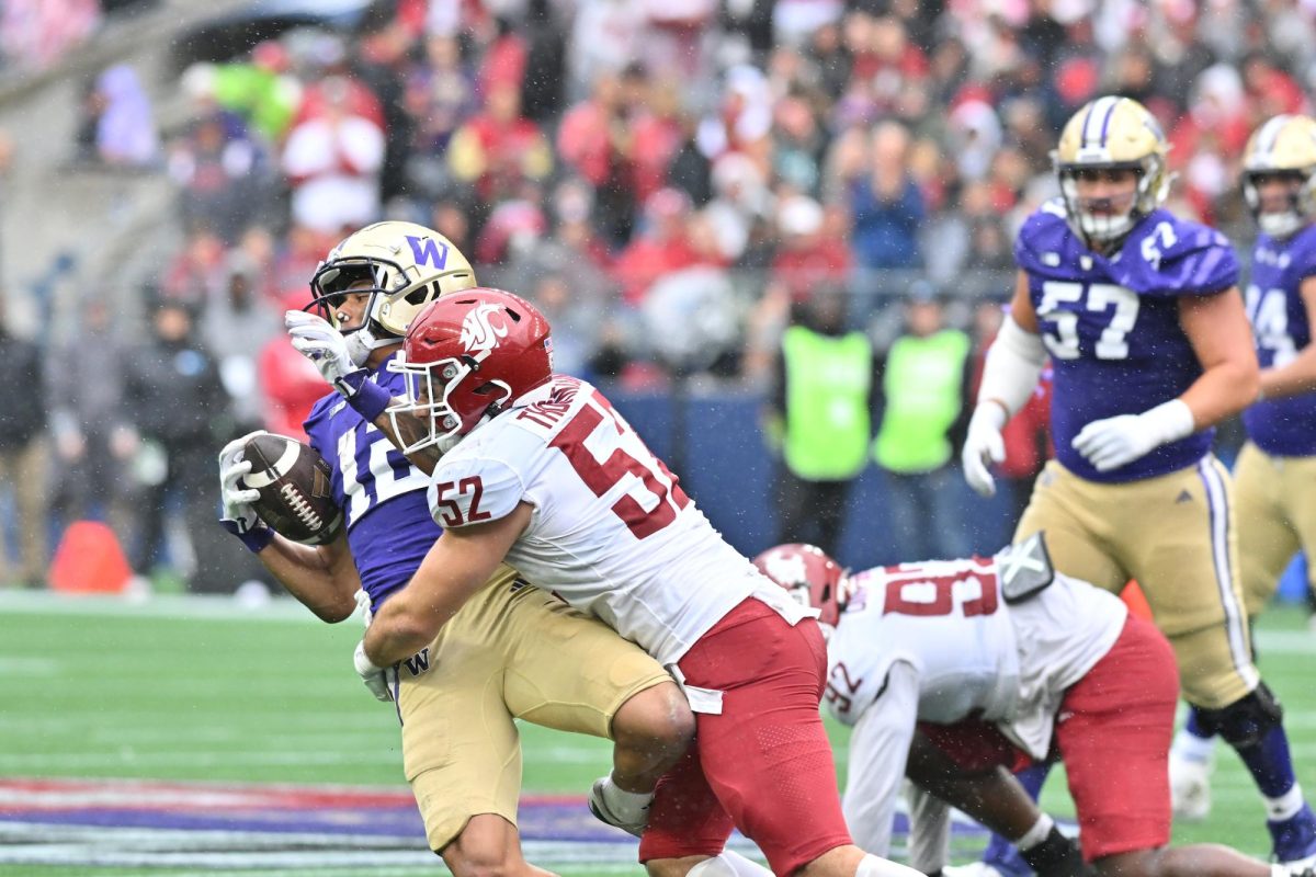 Linebacker Kyle Thornton tackles a Husky receiver to prevent a touchdown in the redzone.