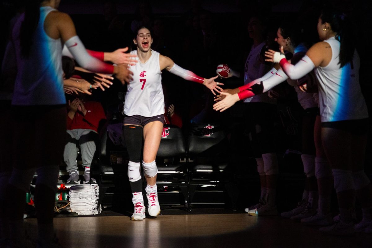 Sage Brustad runs out and high-fives teammates after being introduced as a starter, Oct. 2, in Pullman, Wash. 