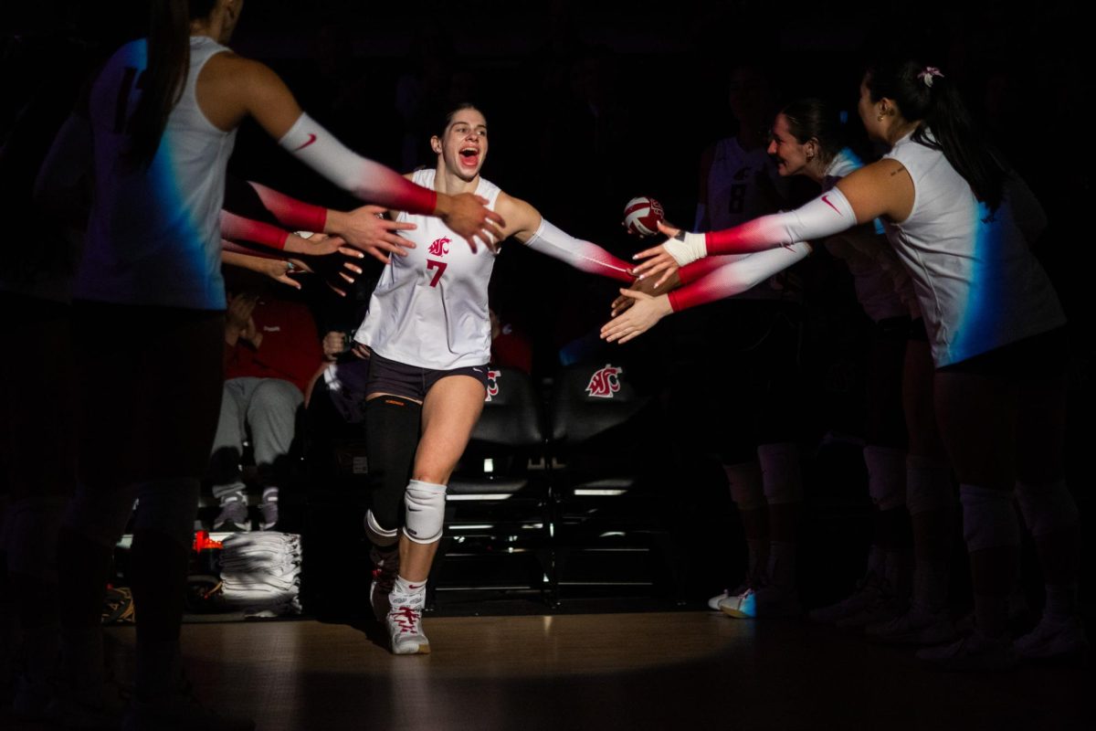 Sage Brustad runs out and high-fives teammates after being introduced as a starter, Oct. 2, in Pullman, Wash. 