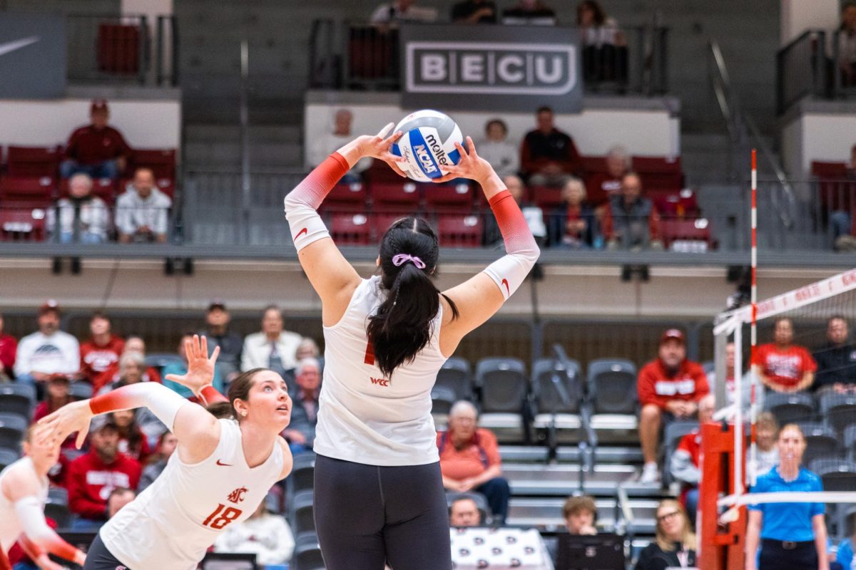 Italia Bernal sets a ball for an attack by Breccan Scheck, Oct. 2, in Pullman, Wash. 