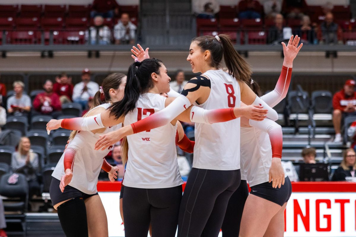 Itaila Bernal (L) and Katy Ryan (R) look at each other after the Cougs scored a point, Oct. 2, in Pullman, Wash. 