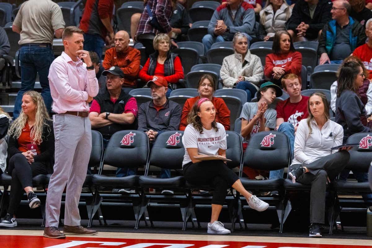 Korey Schroeder (L) and his staff observe the WSU volleyball offense, Oct. 2, in Pullman, Wash. 