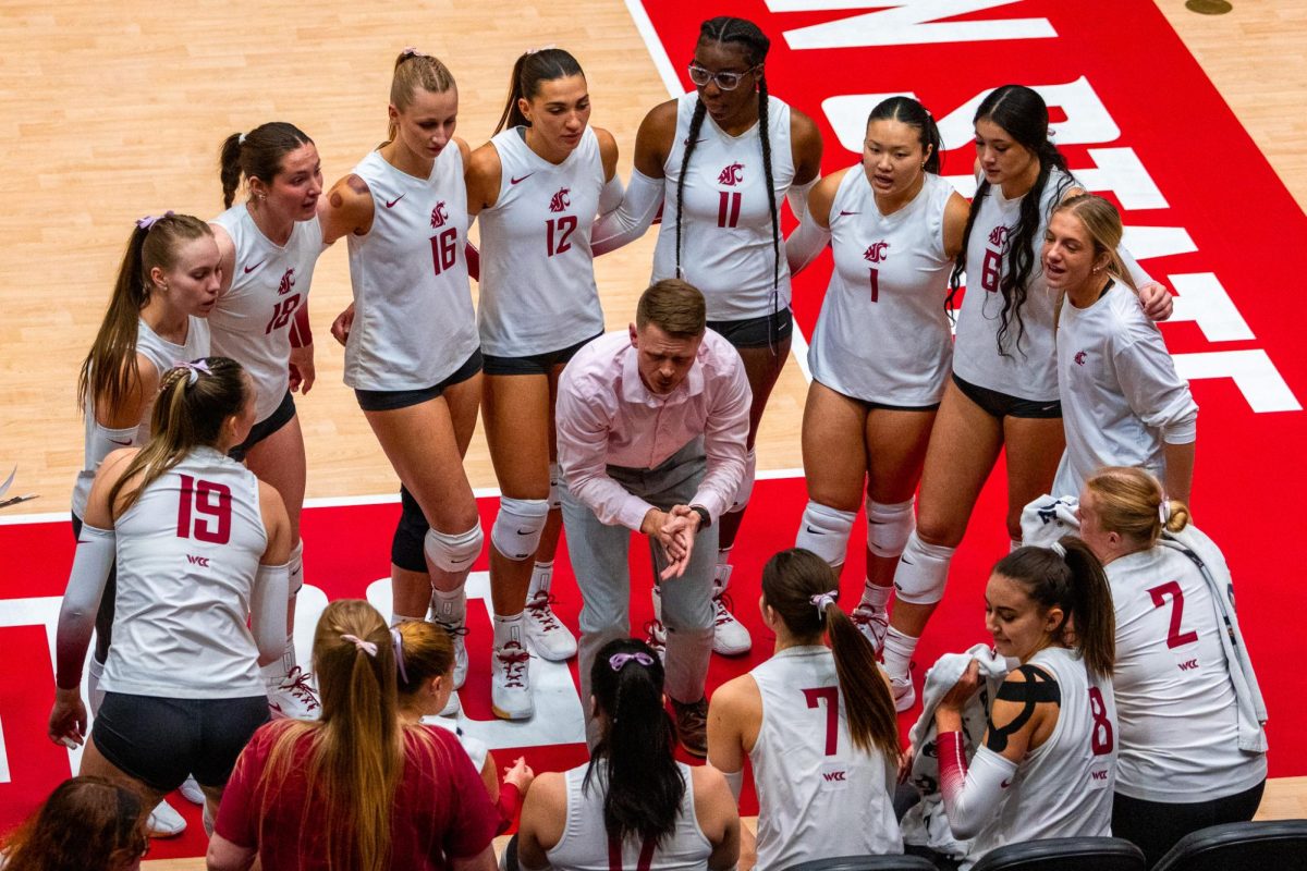 Head coach Korey Schroeder breaks a huddle for the Cougs, Oct. 2, in Pullman, Wash. 