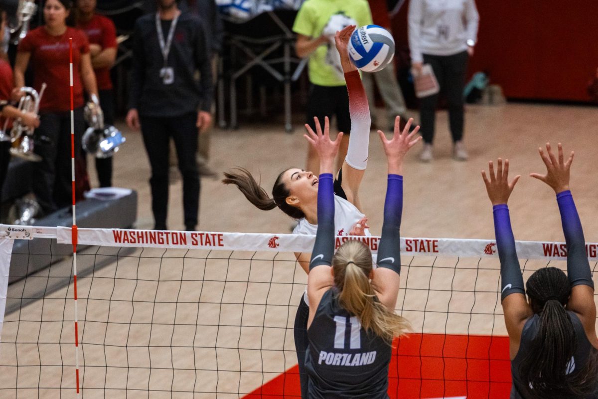 Katy Ryan connects with the ball at the net, Oct. 2, in Pullman, Wash. 