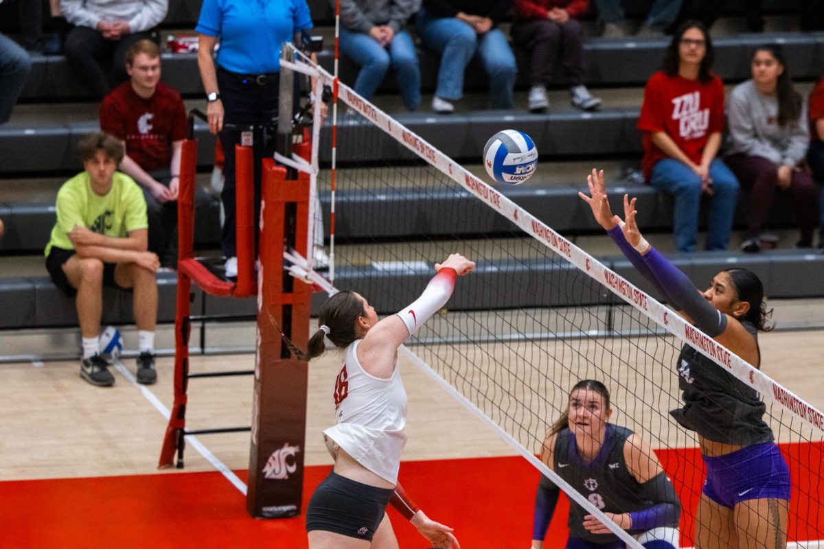 Breccan Scheck softly hits the ball just beyond a defender at the net, Oct. 2, in Pullman, Wash. 