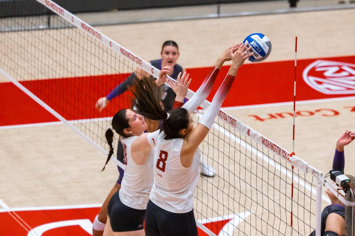 Katy Ryan reaches out over the net to stuff down a Portland attack attempt, Oct. 2, in Pullman, Wash. 