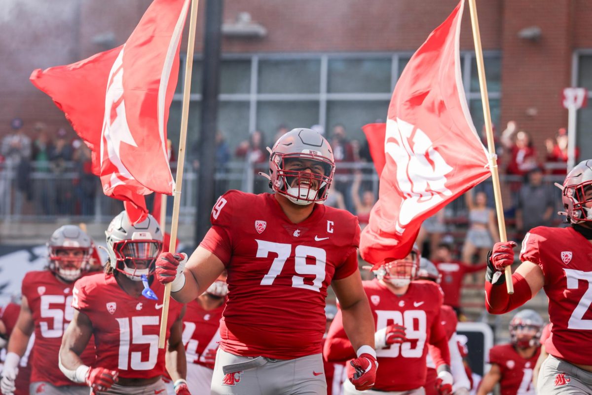 WSU offensive lineman Fa'alili Fa'amoe leads out the Cougs before a game vs Hawai'i.