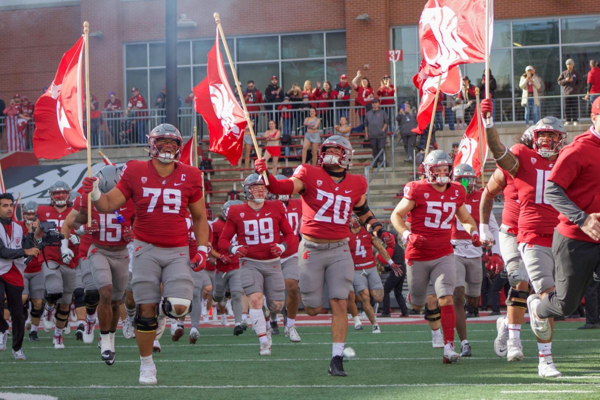 Cougs run out of the tunnel before a game against Hawaii at Gesa Field.