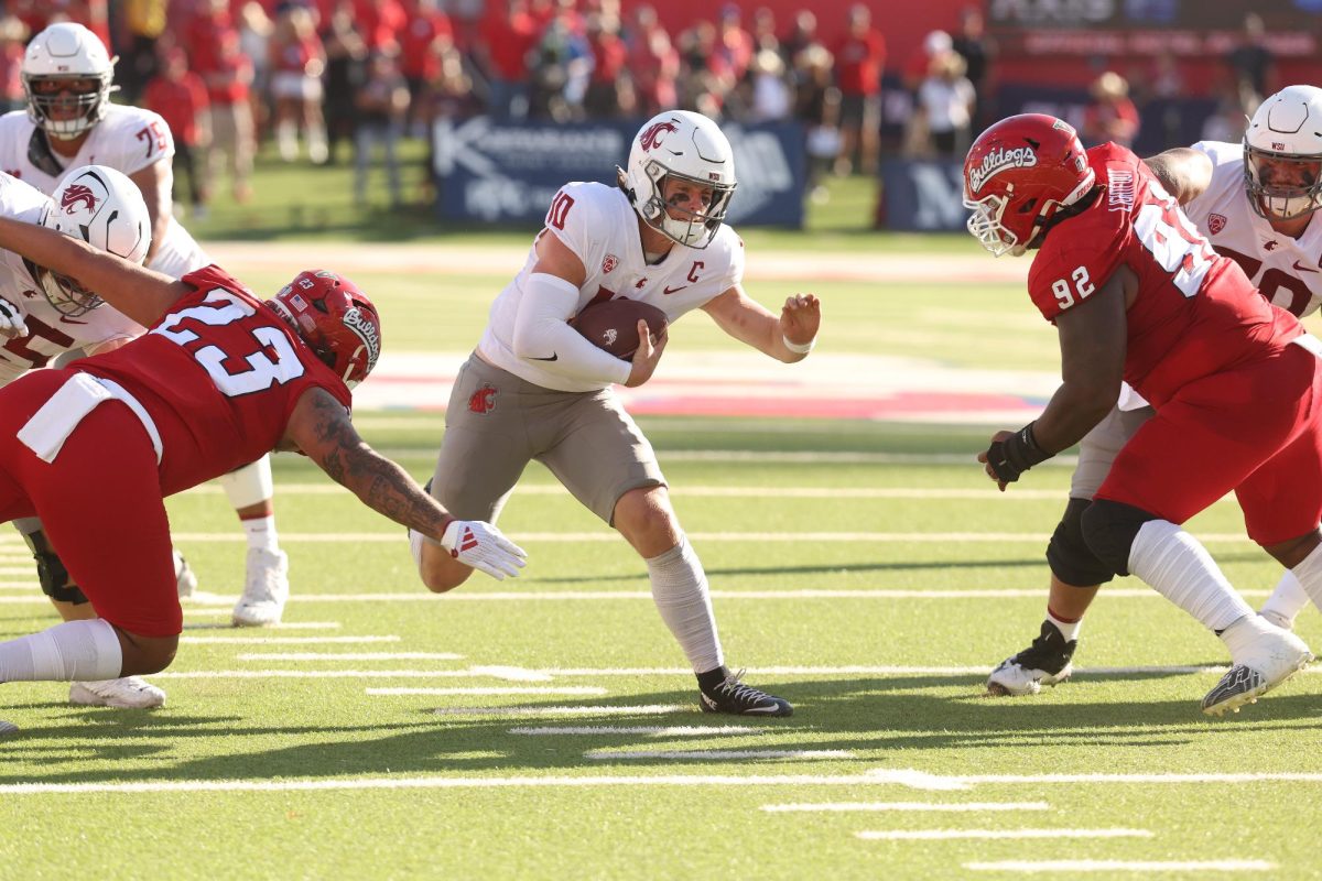 WSU QB John Mateer runs through the Fresno State defense in a 25-17 WSU football win in Fresno, Calif.