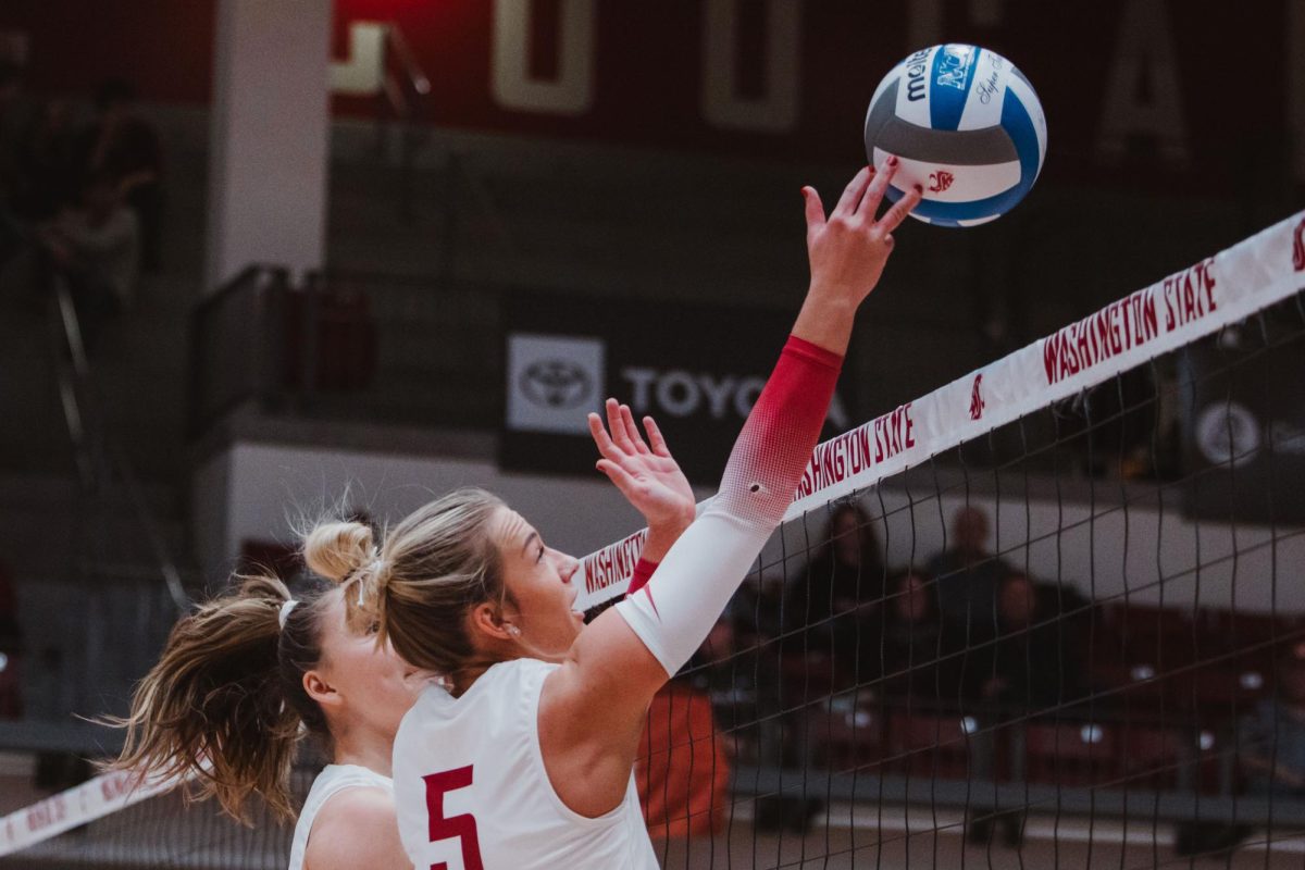 Jaden Walz gets fingers on her the ball at the net to stop a Saint Mary's attack, Nov. 9, in Pullman, Wash. 