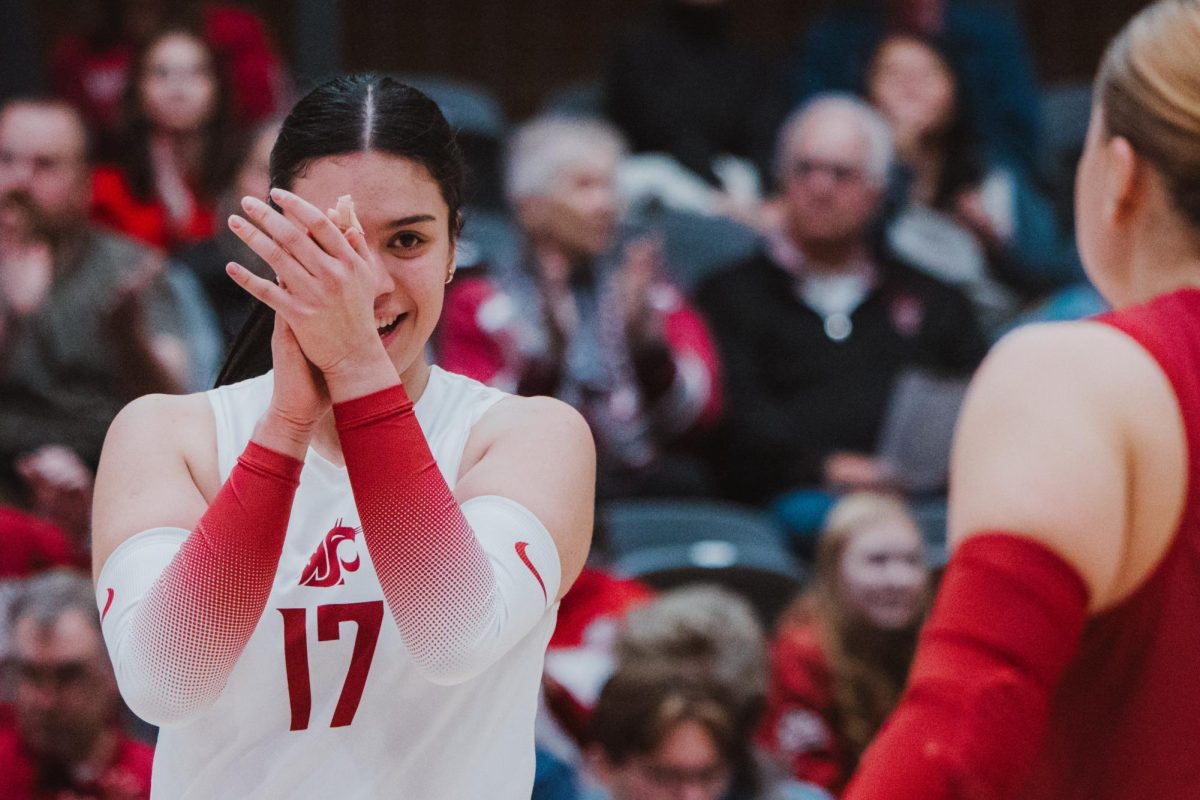 Italia Bernal looks at Emma Barbero after she made a diving play to keep the point alive for the Cougs, Nov. 9, in Pullman, Wash. 