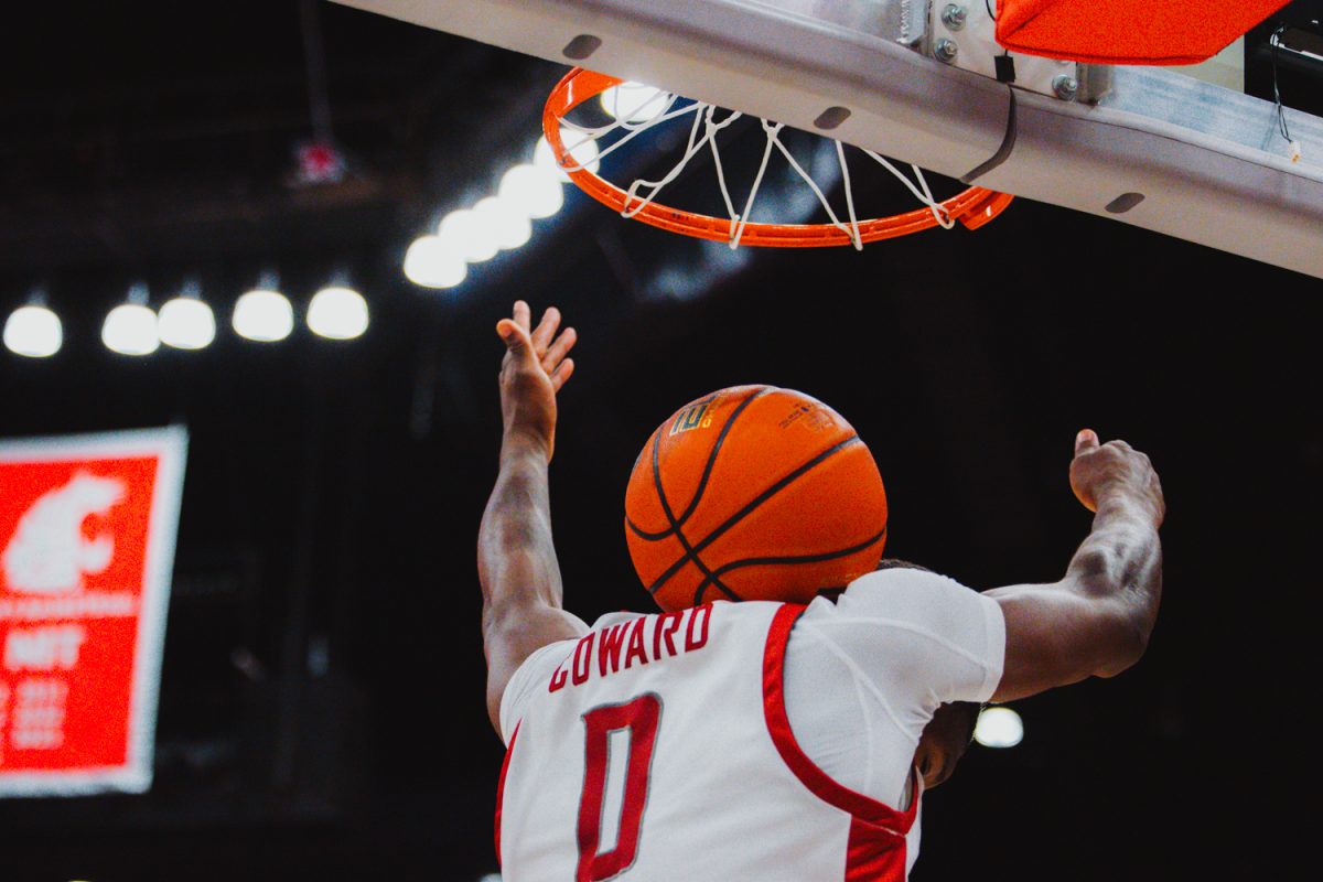 Cedric Coward wears the basketball on his shoulders after dunking the ball, Nov. 9, in Pullman, Wash. 