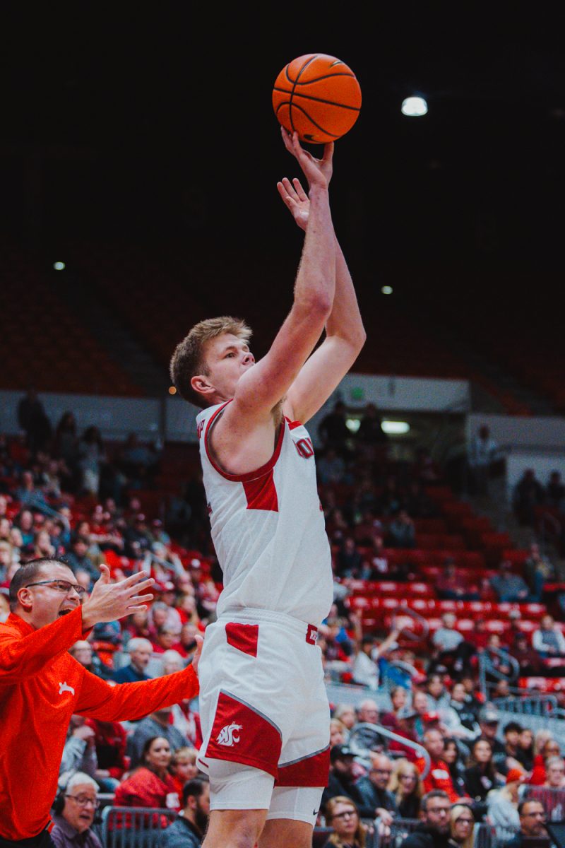 Dane Erikstrup attempts a corner three with the Bradley head coach complains behind him, Nov. 9, in Pullman, Wash. 