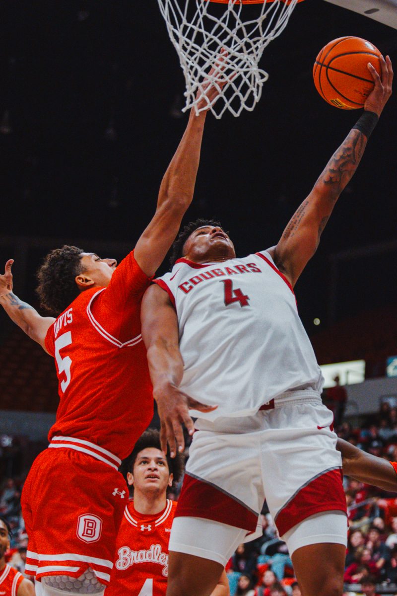 LeJuan Watts keeps separation at the basket for a layup attempt, Nov. 9, in Pullman, Wash. 