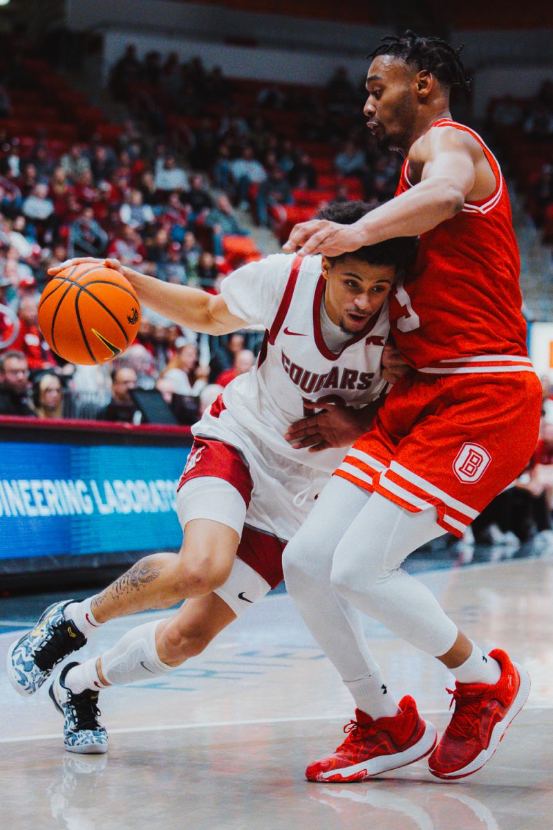 Isaiah Watts puts his shoulder into a defender as he drives to the basket, Nov. 9, in Pullman, Wash. 