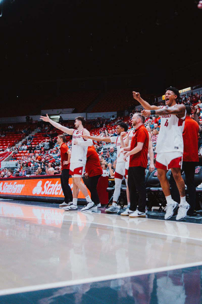 LeJuan Watts and the WSU bench celebrates Tomas Thrastarson's first career points, Nov. 9, in Pullman, Wash. 