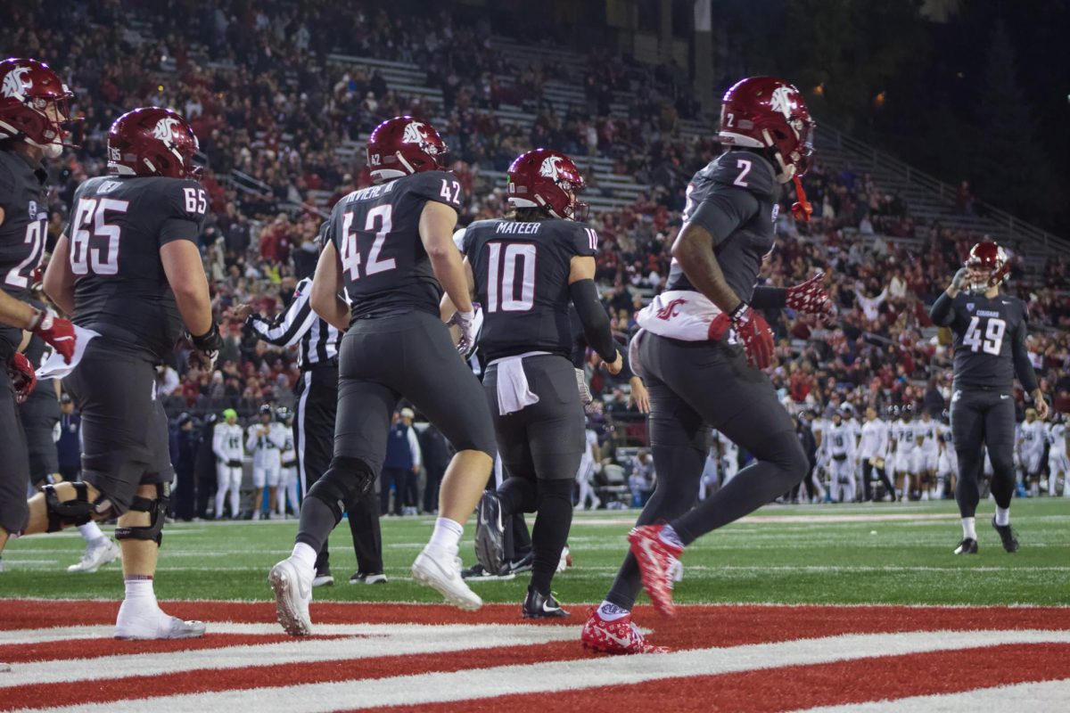 WSU QB John Mateer and the offense run off the field after a score.