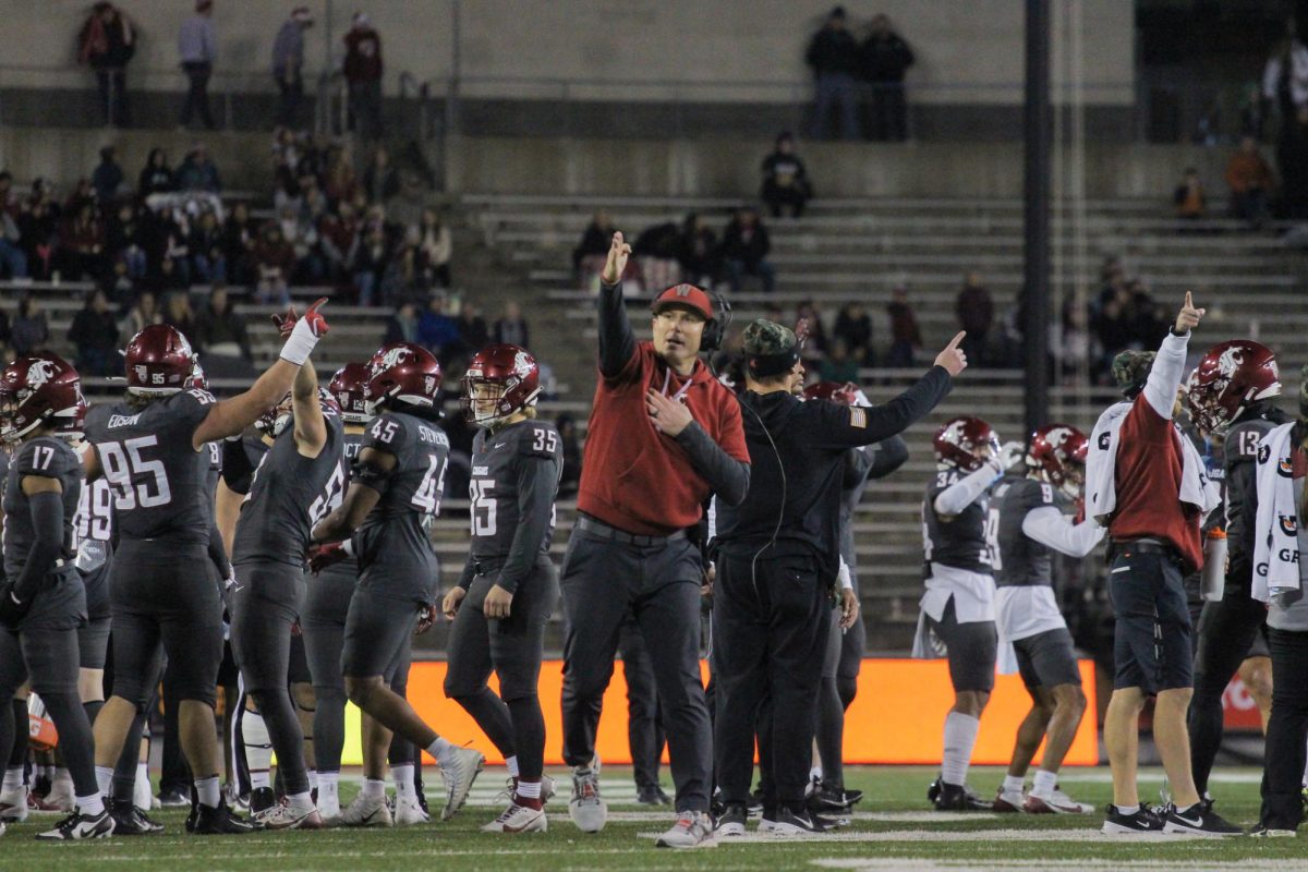 WSU head coach Jake Dickert signaling first down.