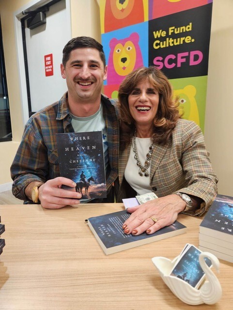 Charles Westerman holding his novel with his mother.